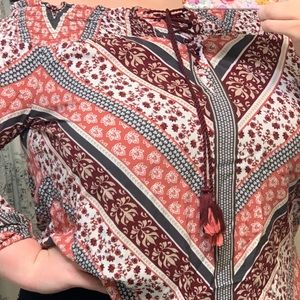 Red, orange, white, black colored blouse